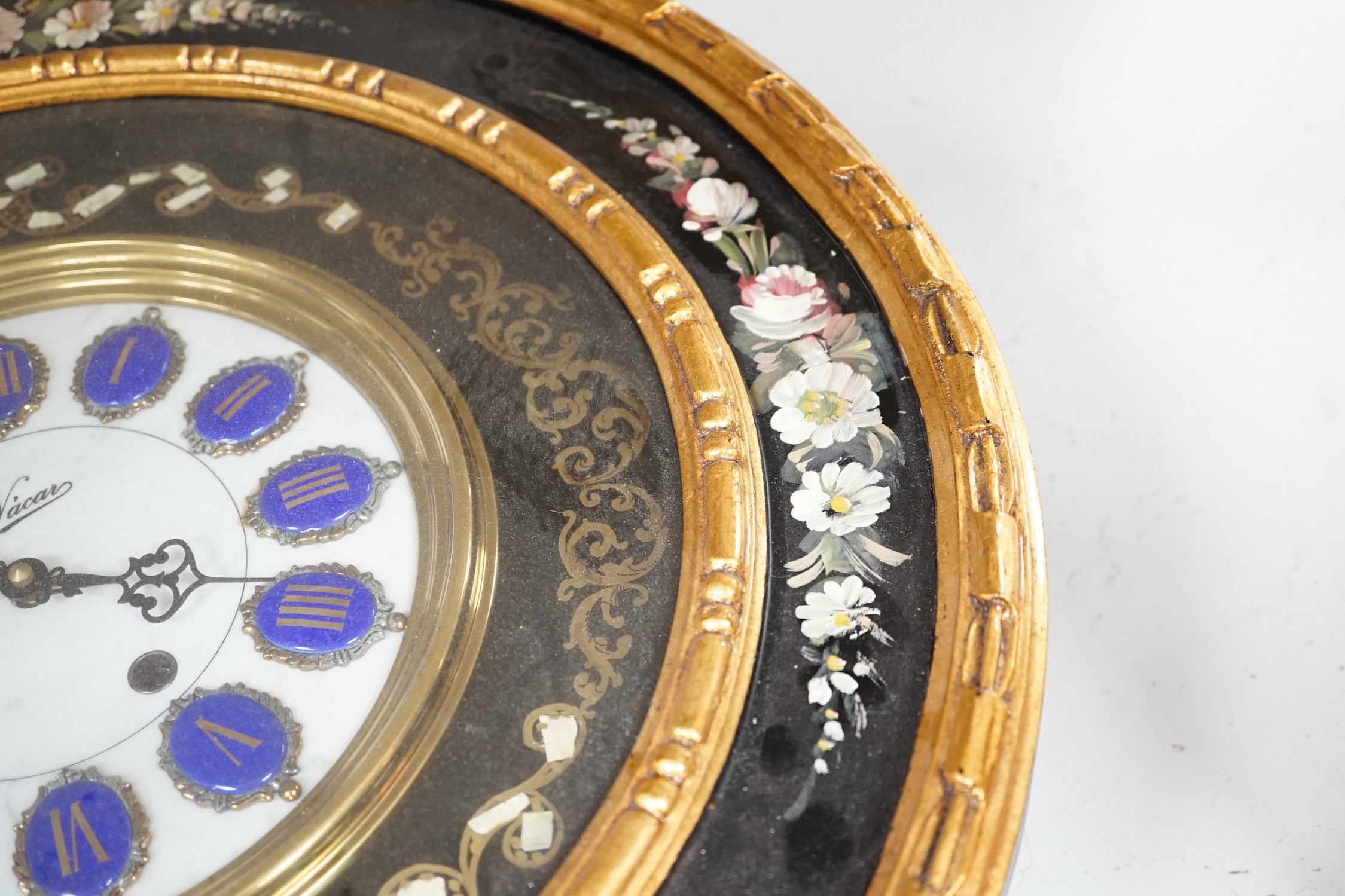 A floral painted clock, length 63cm, quartz movement